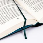 Die Nummer 186 ist mittig auf einer Buchseite zu sehen, begleitet von einem Lesezeichen.