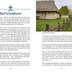 **Bad Windsheim**: Beschreibung und Geschichte des Freilandmuseums. Foto: Fachwerkgebäude mit Strohdach und Holzzaun im Grünen.