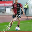 Text "Tim Janisch" oben, "Vorausabbildung" diagonal, 1. FCN Logo, Spieler in rot-schwarzem Trikot, Kalender für April.