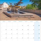 Kalender für April 2027, mit einem Foto einer Skulptur von Tauben über einem Brunnen, bei strahlend blauem Himmel.