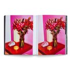 Nummern 102 und 103 unten. Zwei identische Fotos von Blumenvasen mit rosa Blumen, einer Kerze und einem Telefon auf einem Tisch.