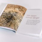 "Wir leben immer länger. Nie zuvor wurden die Menschen älter als im 21. Jahrhundert." Links: Baumringe. Buch offen.