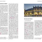 "Willkommen in Lübeck" und "Kurztrip nach Lübeck". Ein Foto zeigt ein beleuchtetes, historisches Gebäude mit zahlreichen Fenstern.