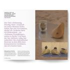 Texte sprechen über Schlamm, See, Berlin und Reibungspunkte. Rechts ist ein Holzobjekt neben einem Glas auf einer Metallfläche. Unten: drei Fotos mit einer Person, die ein tropfenförmiges Objekt bearbeitet.