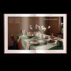 Text: "Afternoon respite". Gedeckter Tisch mit Blumen und Teeservice, sanftes Licht fällt auf grüne Tischdecke.
