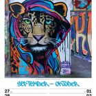 "September - Oktober", "KW39/2027", "Tag der Deutschen Einheit". Graffiti eines Leoparden mit bunter Kapuze an einer Wand.