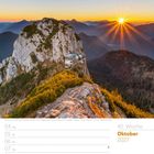 40. Woche, Oktober 2027. Wochenkalender mit Alpinemotiv: Sonnenaufgang über Berggipfeln und Hütte.