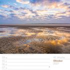 Oktober 2027, Kalenderwoche 40. Wattenmeer in Sankt Peter-Ording, mit blauem, teils bewölktem Himmel und spiegelnden Wasserflächen.