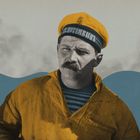 Der Text "БРОНЕН. ПОТЕМКИН" ist auf der Mütze eines ernsten Mannes in Matrosenkleidung.