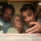 Vier Personen schauen konzentriert und nachdenklich in einen offenen Schrank oder Raum.