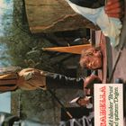 Text: "ISABELLA - Mit blanker Brust und spitzen Degen." Ein Kopf liegt am Boden, ein Fuß ruht auf ihm, im Hintergrund Soldaten.