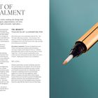 THE ART OF CONCEALMENT. YSL BEAUTY TOUCHE ÉCLAT ILLUMINATING PEN. Ein goldener Stift mit Pinselspitze auf blauem Hintergrund.