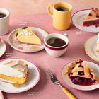 Peach Pie, page 171. Key Lime Pie, page 176. Cherry Pie, page 174. Lemon Meringue Pie, page 175. Banana Cream Pie, page 177. Boysenberry Pie, page 170. Verschiedene Kuchenstücke und Kaffeetassen auf rosa Tischdecke.