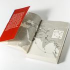 Roter Text auf einer Klappe, darunter eine Karte mit einer markierten Reiseroute, die durch Asien führt.