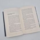 Text: "Marie, Schleswig-Holstein, Dezember 1944". Geöffnetes Buch mit zwei bedruckten Seiten.