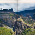 "REUNION" und Text auf linker Seite über die Insel im Indischen Ozean, bewaldete Berge mit dramatischem Himmel im Hintergrund.