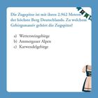 Die Zugspitze ist mit ihren 2.962 Metern der höchste Berg Deutschlands. Zu welchem Gebirgsmassiv gehört die Zugspitze? a) Wettersteingebirge b) Ammergauer Alpen c) Karwendelgebirge. Daneben ist ein Dirndl illustriert.