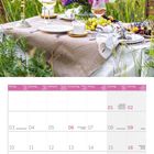 Kalender für Mai 2027 mit Feiertagen. Oben: Gedeckter Tisch im Freien mit Blumenarrangement.