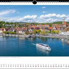 "Oberlinger Landungsplatz mit dem ehemaligen Handels- und Kornhaus Greth – markant das Münster St. Nikolaus."  
Kalender mit Blick auf eine Stadt am Wasser, ein großes Boot fährt vorbei.