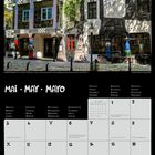 Am oberen Rand steht „MAI • MAY • MAYO“. Darunter ein Foto eines kunstvollen Gebäudes mit unregelmäßigen Mustern und Farben.