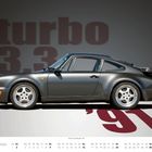 Text: "turbo 3.3", "'91", "MAI". Ein grauer Sportwagen im Profil vor grauem Hintergrund. Kalender unten.