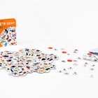 Schachtel "ERSTE*R SEIN SAFARI" zeigt ein Suchspiel mit Tieren, Karten und Marken. Orange Verpackung und weiße Karten.