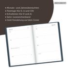 Mehrere Features eines Planers: Monats- und Jahresübersichten, Feiertage, Schulferien, Satinband, Goldcover. Zeigt eine Kalenderwoche.