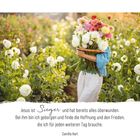 "Jesus ist Sieger und hat bereits alles überwunden..." Eine Person trägt einen großen Blumenstrauß inmitten eines Feldes.