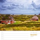 47. Woche, November 2027. Reetgedeckte Häuser in Hörnum, Insel Sylt. Grüne Dünenlandschaft, wolkiger Himmel im Hintergrund.