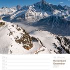 Kalenderwoche 48, November/Dezember 2027. Schneebedeckte Alpen, blauer Himmel, Winterlandschaft.