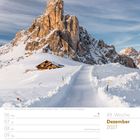 49. Woche, Dezember 2027, Kalender mit schneebedeckter Berghütte vor einem eindrucksvollen Berggipfel.
