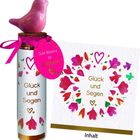 "Gute Wünsche zur Kommunion. Glück und Segen" sind mit Herzen und Blumen verziert. Ein rosafarbener Vogel krönt das Ganze.