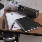 "Do what is round to permit thought to change direction." Schwarzes Mäppchen, Notizblöcke, Stifte auf einem Tisch.