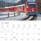 Kalenderseite für Dezember 2027 mit rotem Zug in verschneiter Berglandschaft, Bernina-Express bei der Montebello-Kurve.