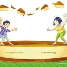 Text: "Nanay bakes the leche flan. It wiggles while we giggle."  
Illustration: Ein Junge und eine Frau balancieren auf einem großen Leche Flan.