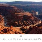 Text: "Fish River Canyon", "6", "CASARES EDITION". 

Beschreibung: Eine imposante Schlucht mit dramatischen, erdigen Felsformationen und einem schmalen Fluss.