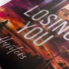Text: "LOSING YOU, Hunters." Hintergrund: Skyline mit Sonnenuntergang in warmen Farben.