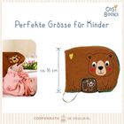 "Perfekte Größe für Kinder. Ca. 16 cm." Ein Baby spielt mit einem weichen Bären-Buch.