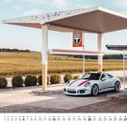 "FREIE T" ist ein Schild auf einem Dach einer ländlichen Tankstelle, darunter ein weißer Sportwagen mit roten Streifen.