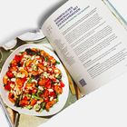 SOMMERLICHER BOHNENSALAT MIT ZUCKERSCHOTEN. Ein Teller bunter Salat mit weißen Bohnen, roten Tomaten und grünen Blättern.