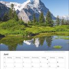 Juni-Kalender mit Foto von Bergen und grüner Landschaft, darunter ein klarer Himmel.