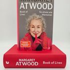„MARGARET ATWOOD. Book of Lives. So etwas wie Memoiren.“ Buch mit Bild einer lächelnden, älteren Frau in Rot.