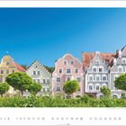 Text: "Landsberg, Nordbayern" und "6". Bunte historische Häuser mit blauen Himmel im Hintergrund, grüne Bäume im Vordergrund.