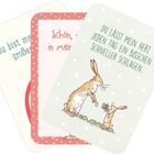 Karte mit Text: "DU LÄSST MEIN HERZ JEDEN TAG EIN BISSCHEN SCHNELLER SCHLAGEN." Illustration von zwei Hasen.
