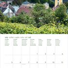 Kalenderseite für Juli mit Tagen in mehreren Sprachen; darüber eine Ansicht einer Burg auf einem Hügel bei Sonnenuntergang.