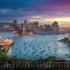 „Skyline von Sydney mit Hafen“ über einem Hafen vor Wolkenkratzern bei Sonnenuntergang, Boote im Wasser.