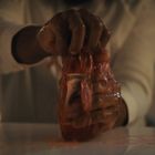 Der Text auf dem Etikett lautet "MOTHER NATURE'S SECRETS". Eine Person drückt eine Flasche mit einer rosa Flüssigkeit aus.