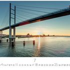 "Rügenbrücke"; Nummern von 1 bis 31; "CASARES EDITION". Sonnenuntergang hinter einer großen Brücke über Wasser.