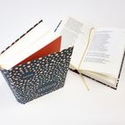 Zwei Bücher mit blauem Einband und goldenen Punkten; eines geöffnet, das andere geschlossen. Text "Reclam" und "DEUTSCHE GEDICHTE".