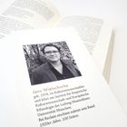 Text über Jens Wietschorke, Kulturwissenschaftler, mit Foto von ihm. Offene Bücher darunter.